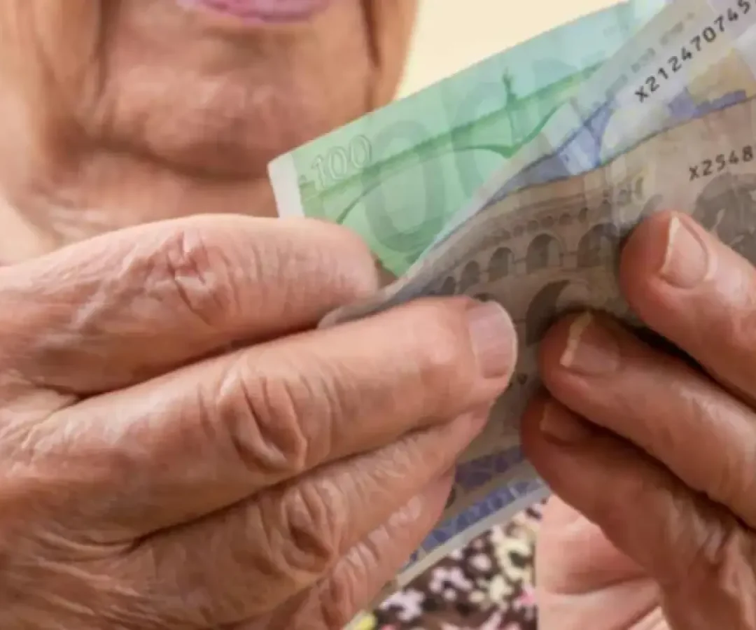 Una mujer, con varios billetes en el mano.